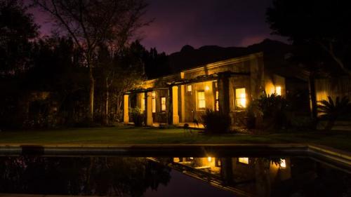 African and Green Garden Cottages at night